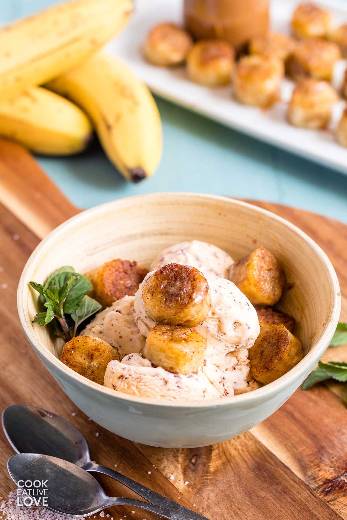 Air fryer bananas on top of a bowl of ice cream.