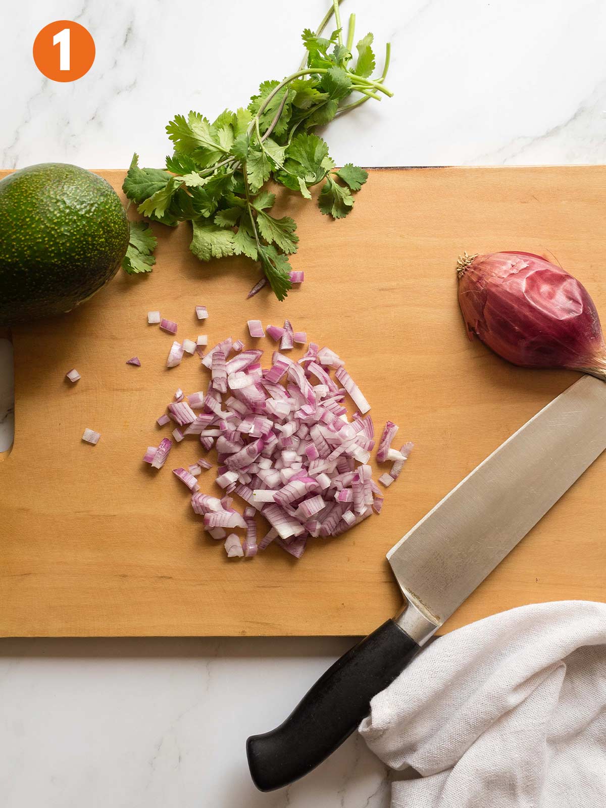 Diced onion on a cutting board to make 4-ingredient guacamole.