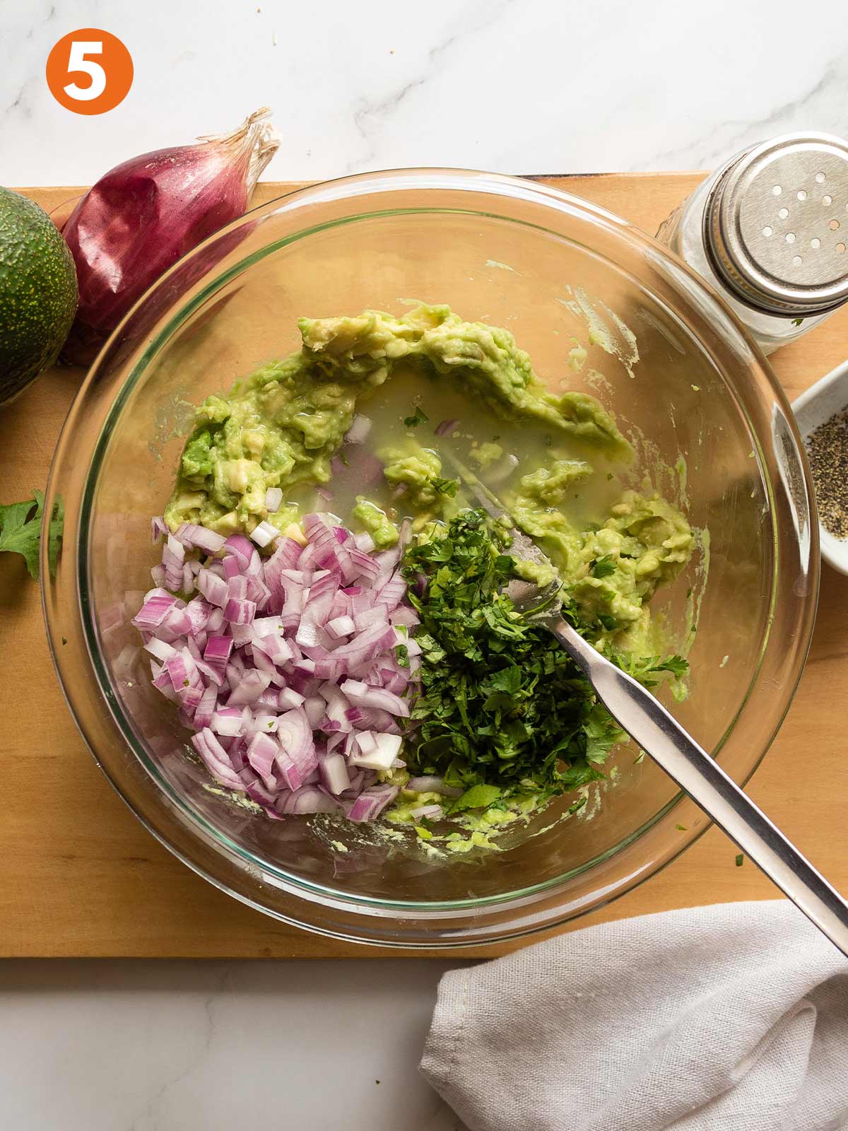 Four ingredients for guacamole in a bowl.