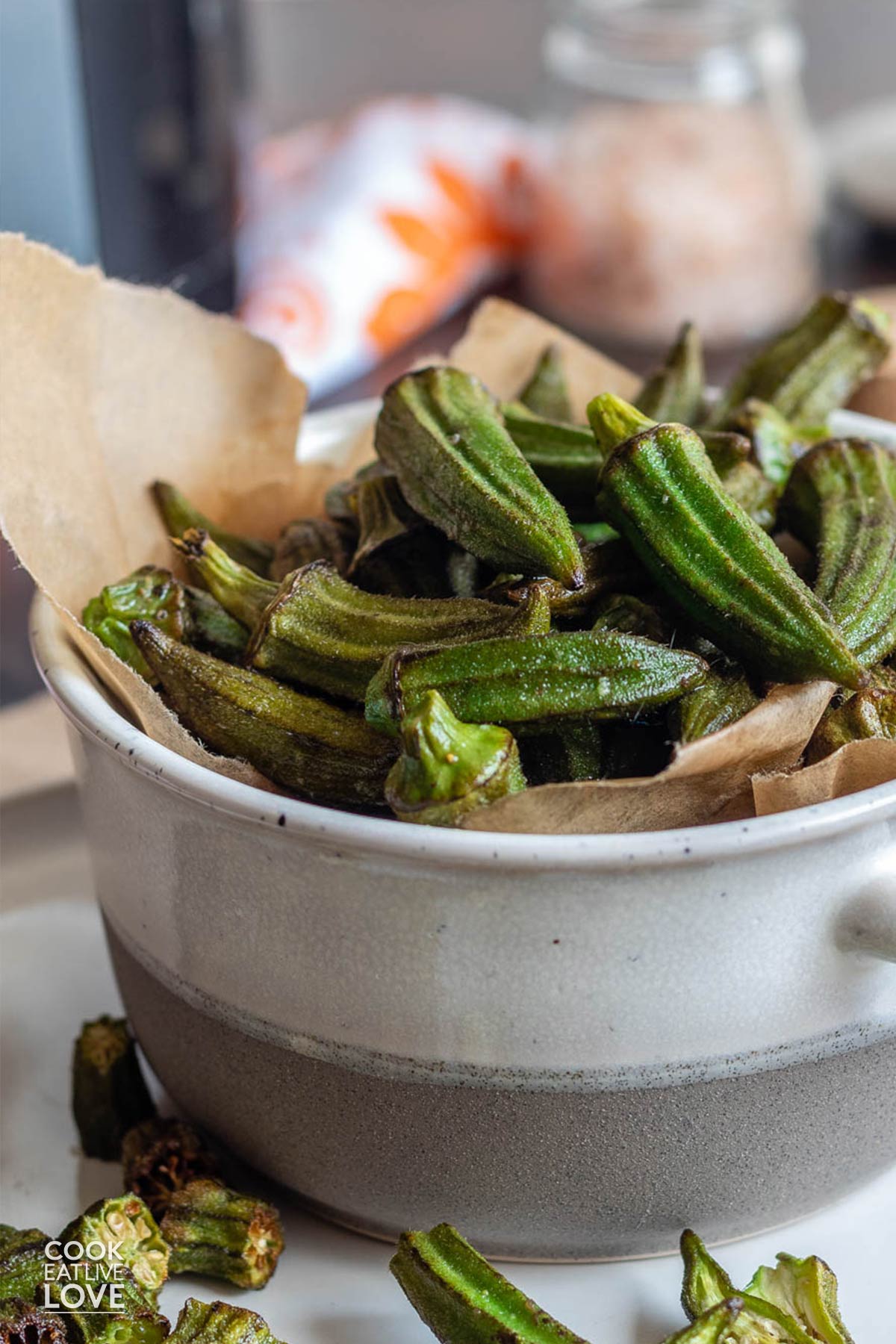Air fried okra in a white and tan bowl on the table.