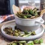 Air fryer okra in a bowl on a plate.