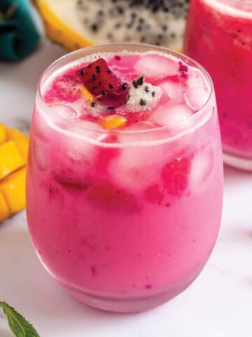Copycat dragon drink in glass with fresh dragon fruit.