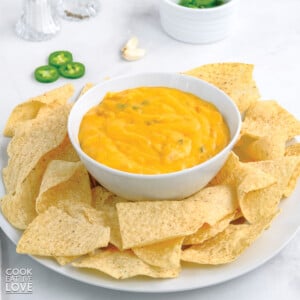 Vegan cheese sauce in a bowl with tortilla chips.
