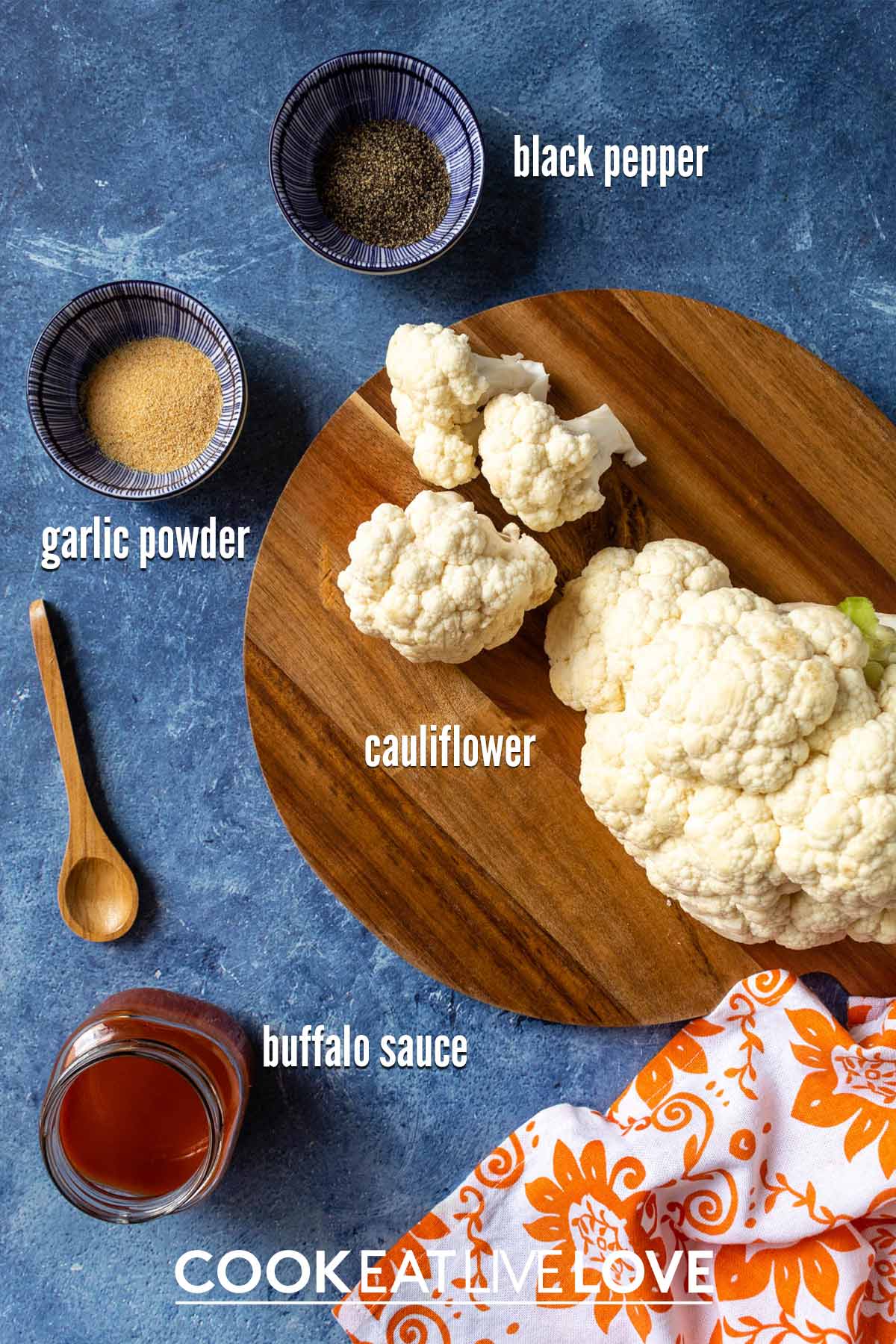 Ingredients to make air fryer buffalo cauliflower on the table with text labels.