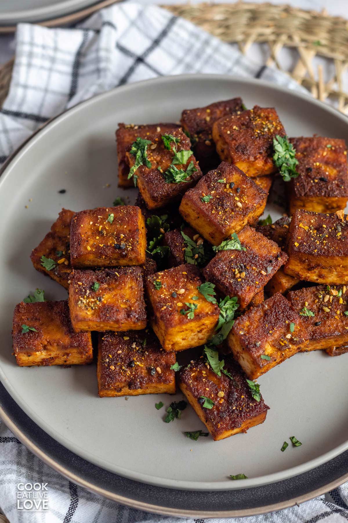 Smoked tofu on a plate garnished with parsley.