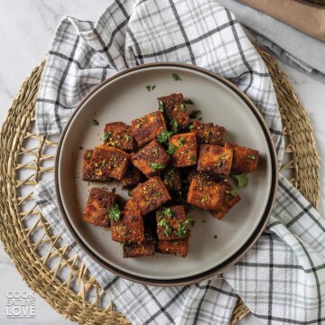 Smoked tofu on a gray plate on the table.