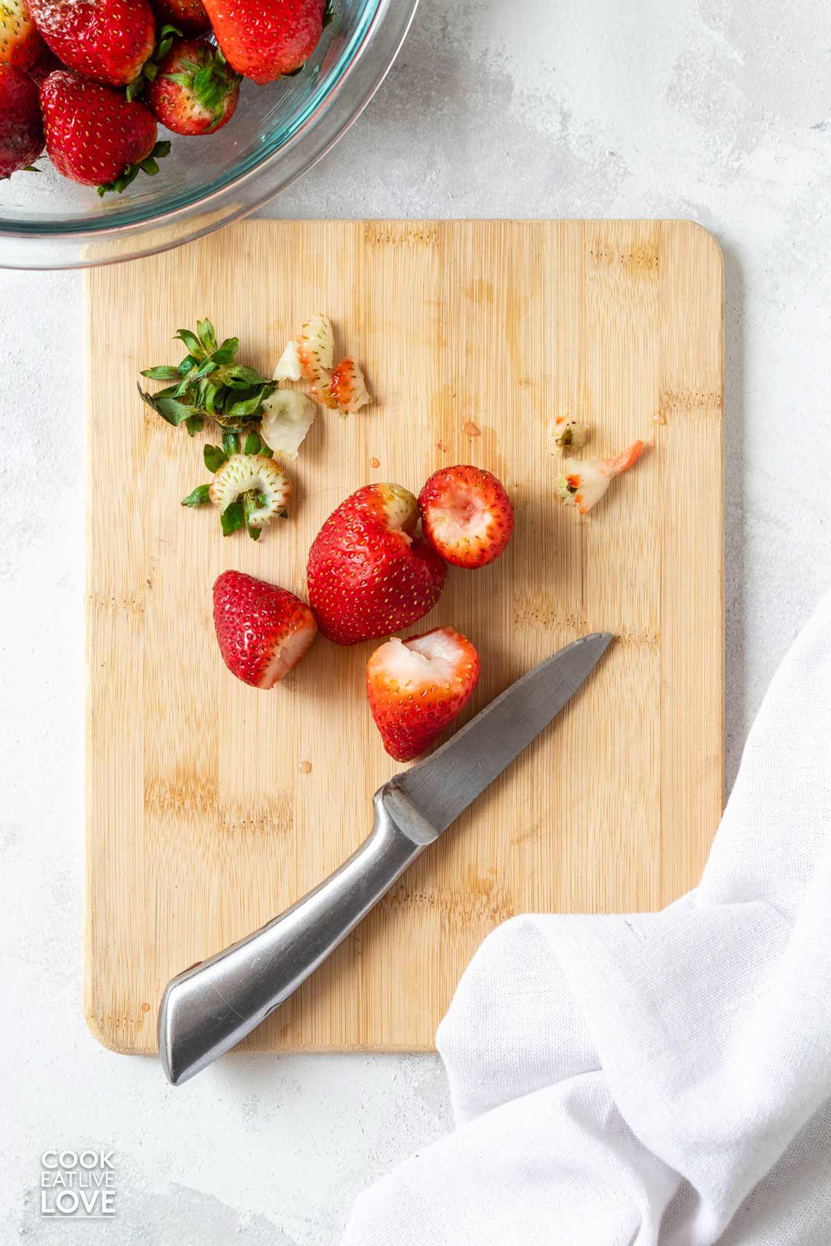 Core cut out of strawberries with a paring knife.