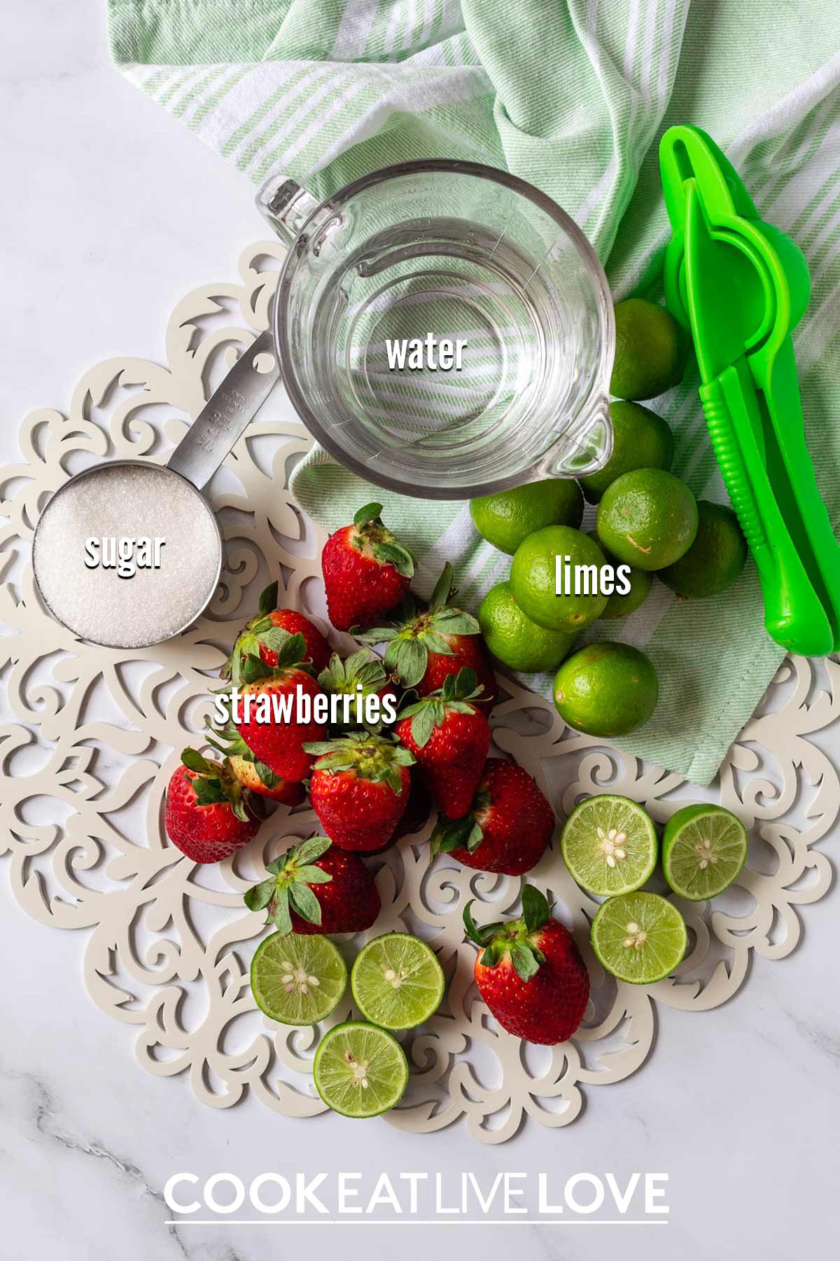 Ingredients to make strawberry limeade on the table.