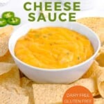 Pin for pinterest graphic with bowl of vegan cheese sauce surrounded by chips.