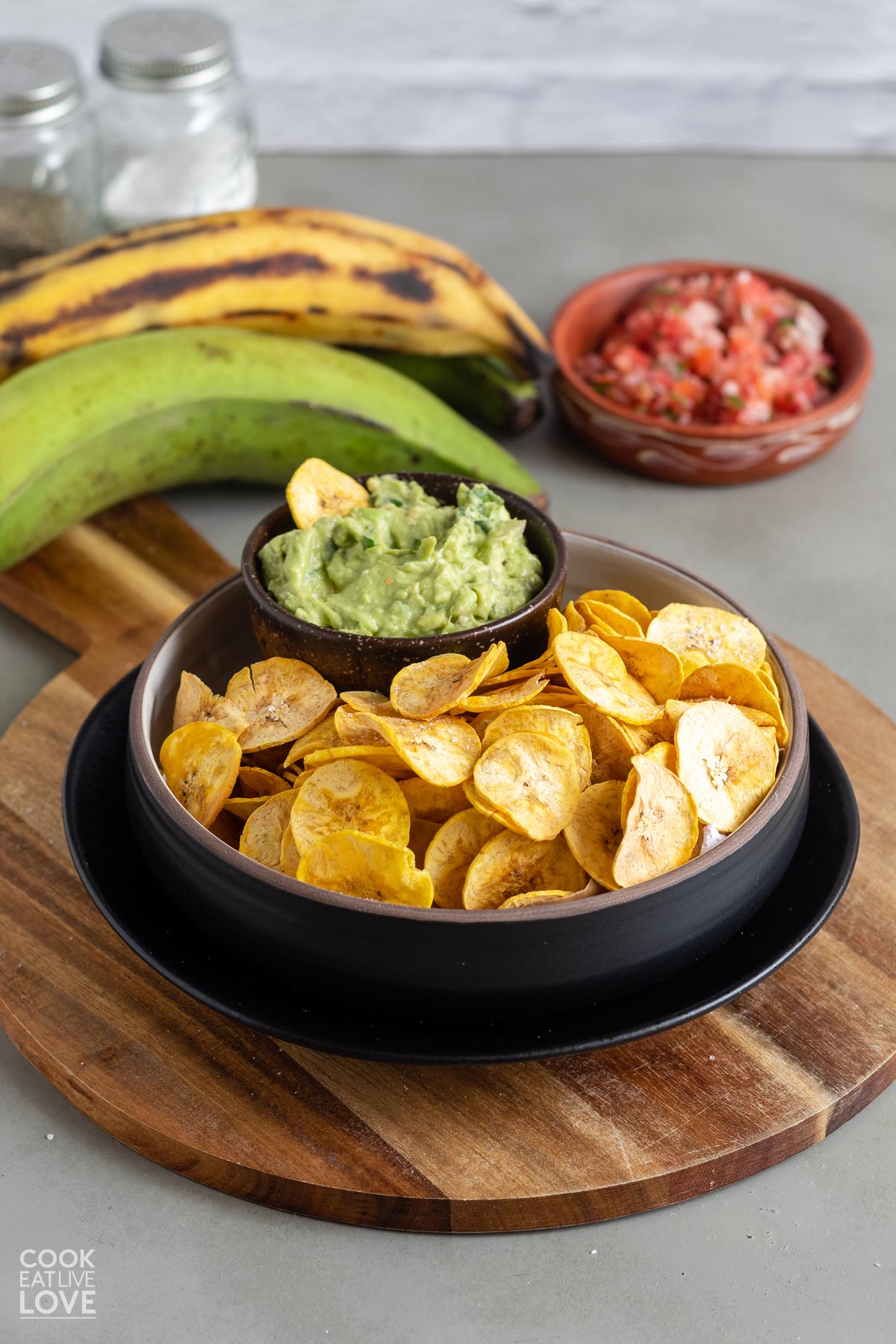 Sweet and savory air fryer plantain chips in a bowl with guacamole.