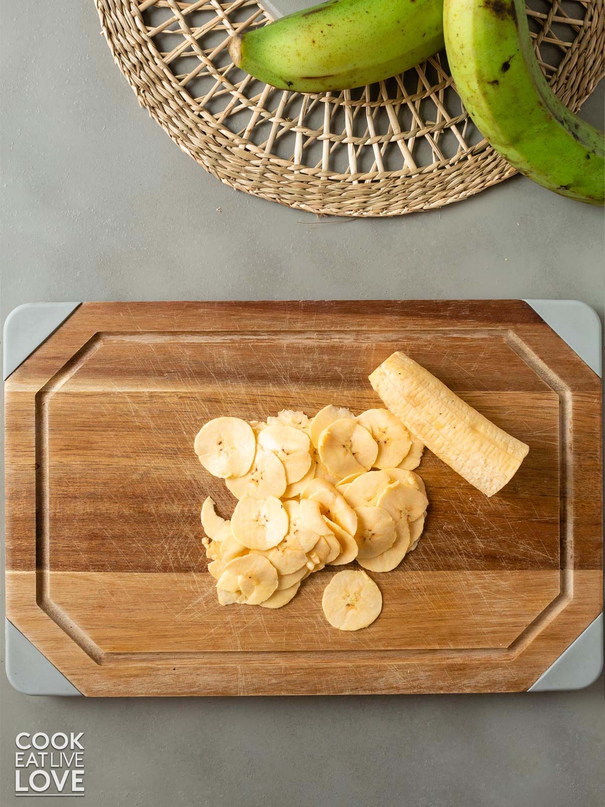PIle of sliced sweet plantains on a cutting board.