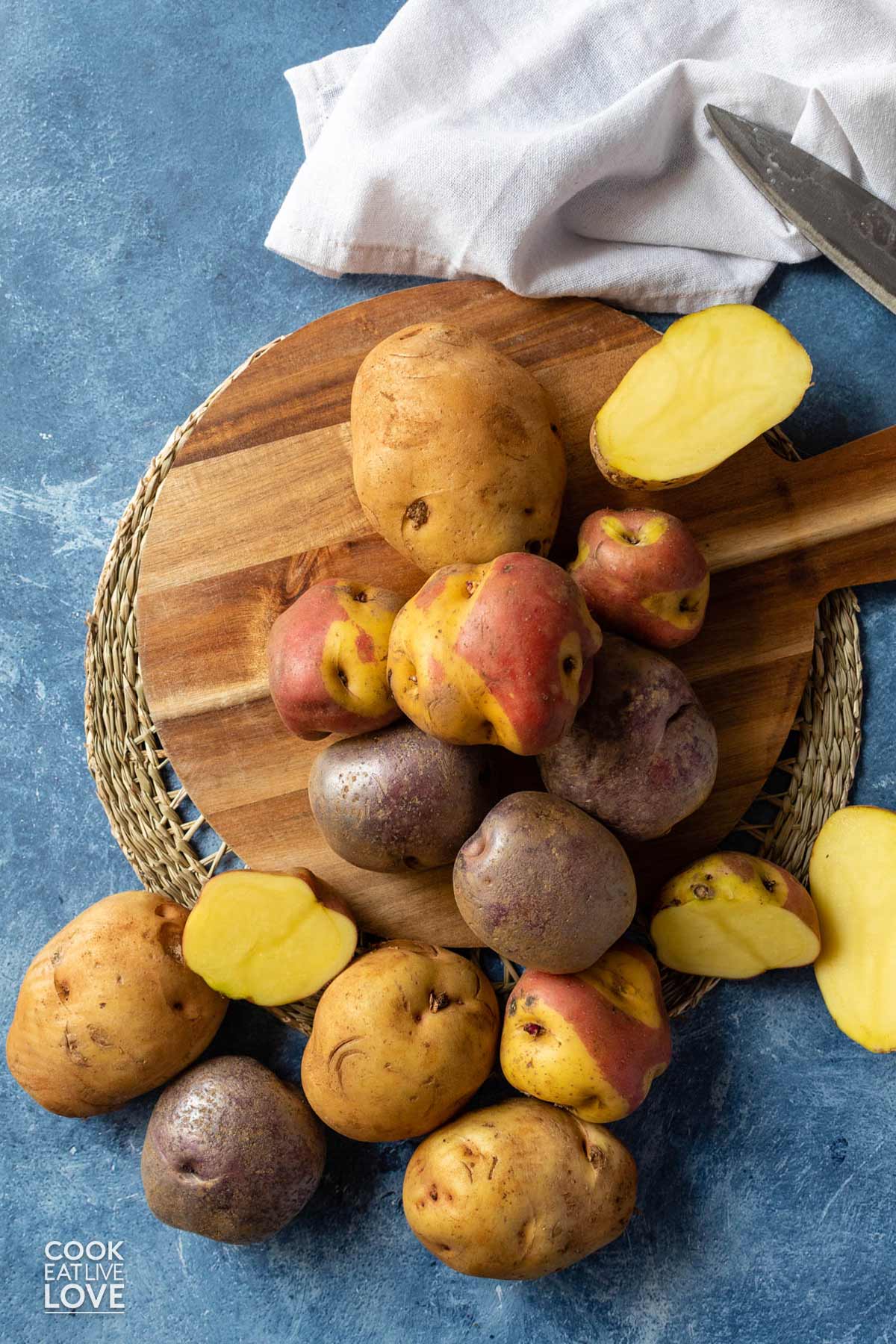 Potatoes on the table to use to cut for fries.
