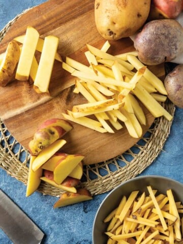 Different cuts of potatoes for french fries on the table.
