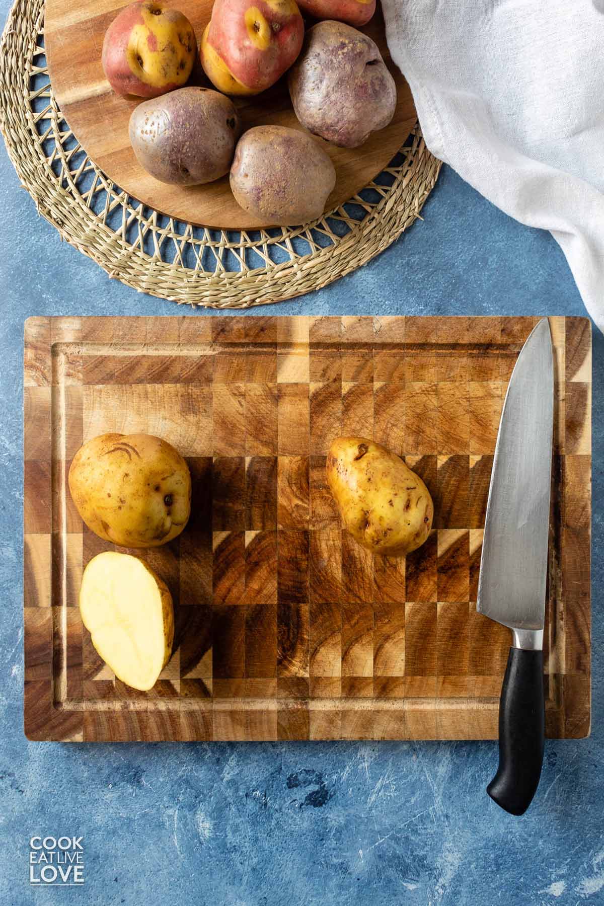 Flat side of potato turned over on the cutting board.