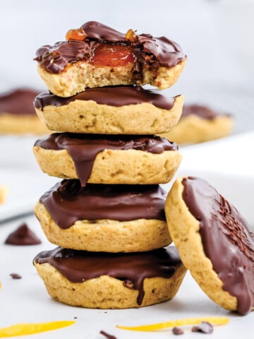 Stack of jaffa cakes with the one on top missing a bite.