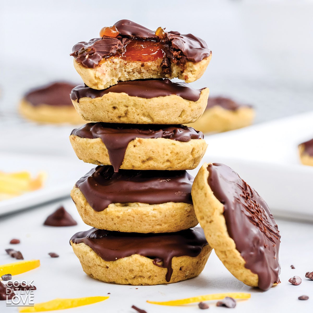 Stack of jaffa cakes with the one on top missing a bite.