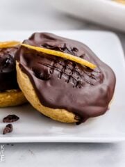 Easy jaffa cakes on a plate garnished with orange peel.