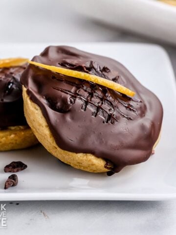 Easy jaffa cakes on a plate garnished with orange peel.