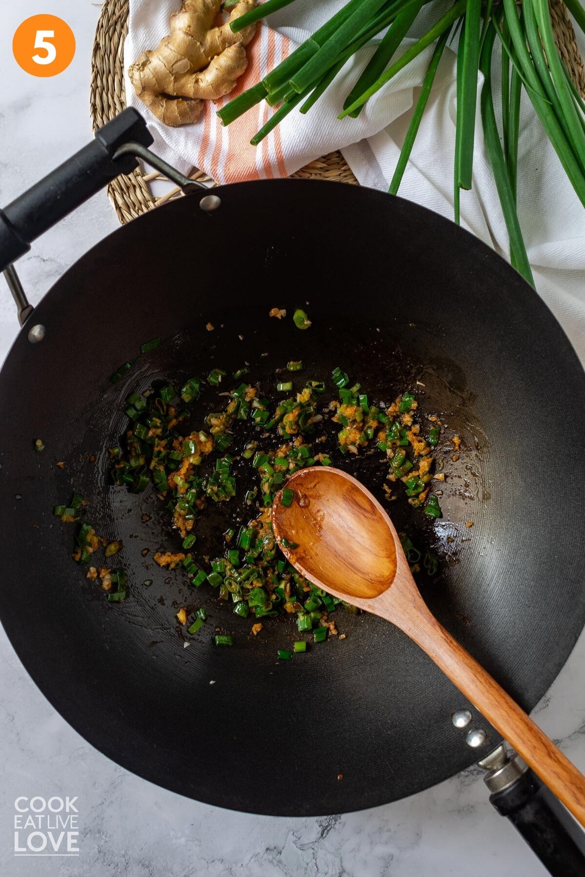 Vegetables cooking in a wok to make orange tofu.