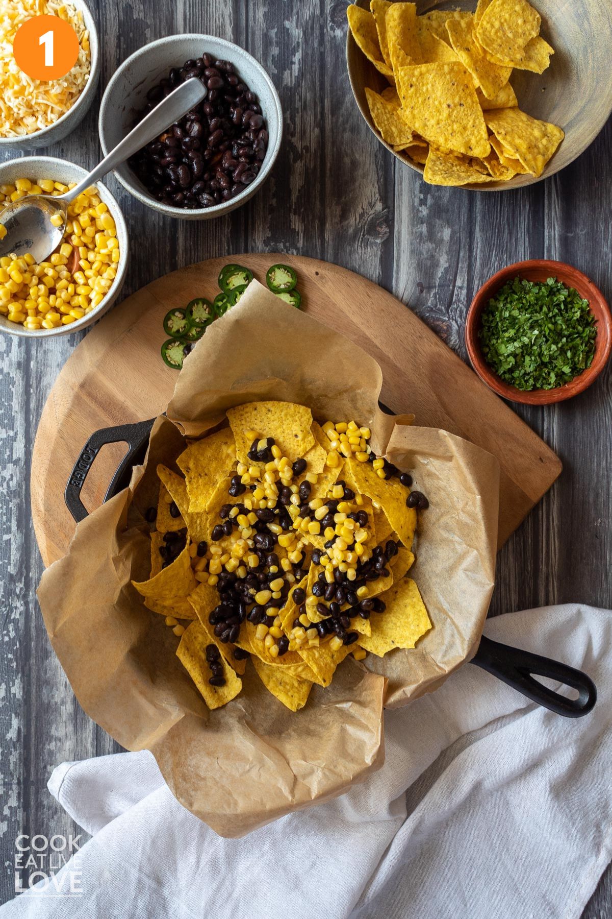 Chips topped with corn and black beans. 