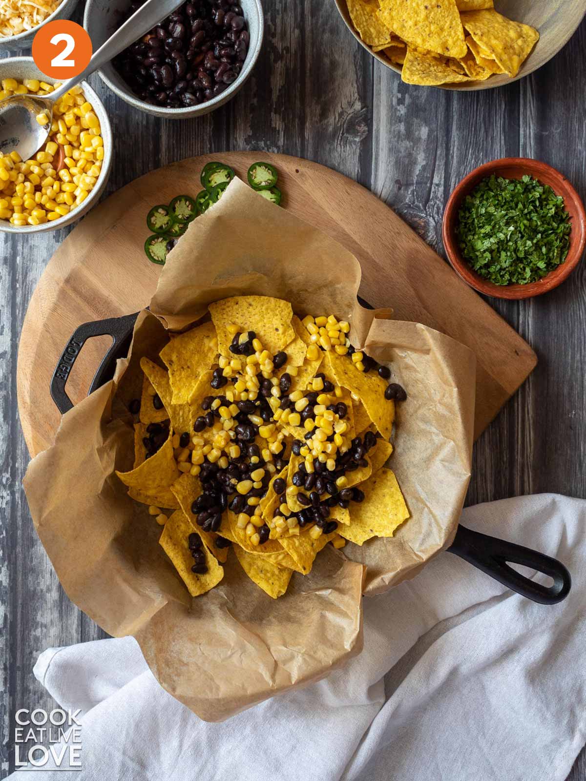 Corn and black beans added on top of the chips to make vegetarian nachos.