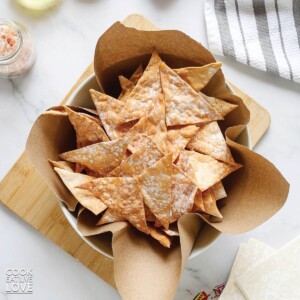 A basket filled with air fryer wonton chips.