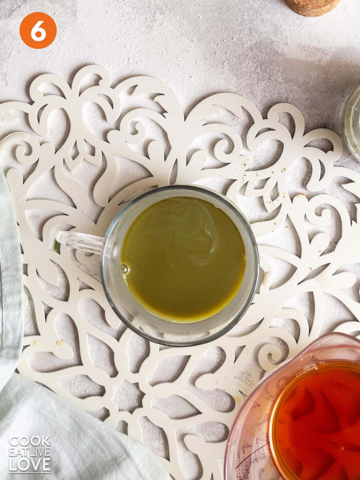 Matcha and chai tea combined in a glass mug.