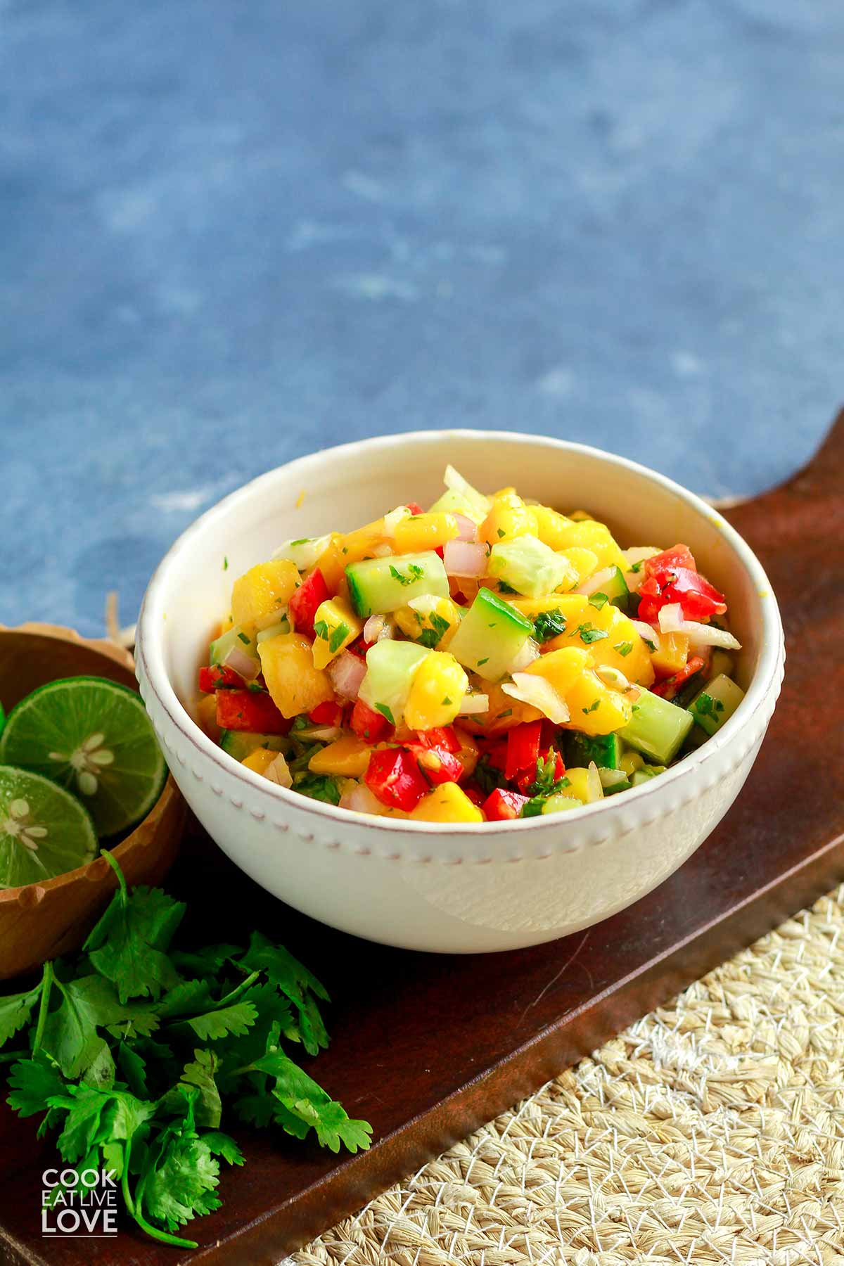A bowl of easy mango salsa on the table.