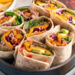Pin for pinterest graphic with image of southwestern veggie wraps in a bowl with text at the top.