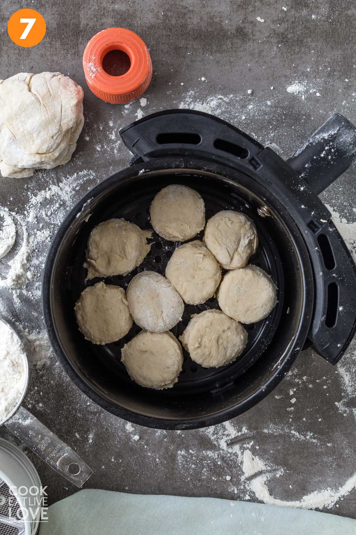 Biscuits laid on the rack in the air fryer basket.