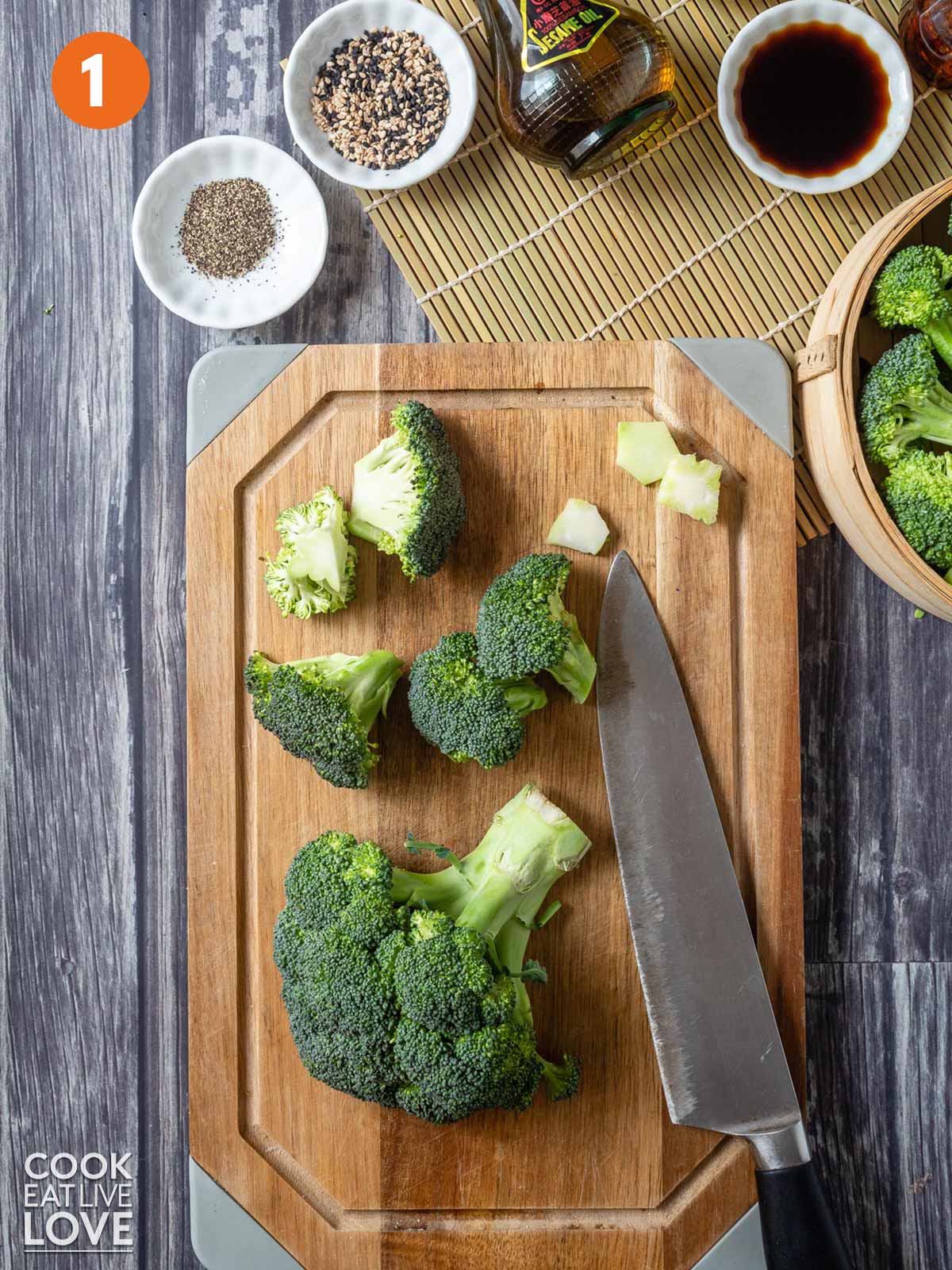 Broccoli florets chopped into small pieces on a cutting board with a knife.