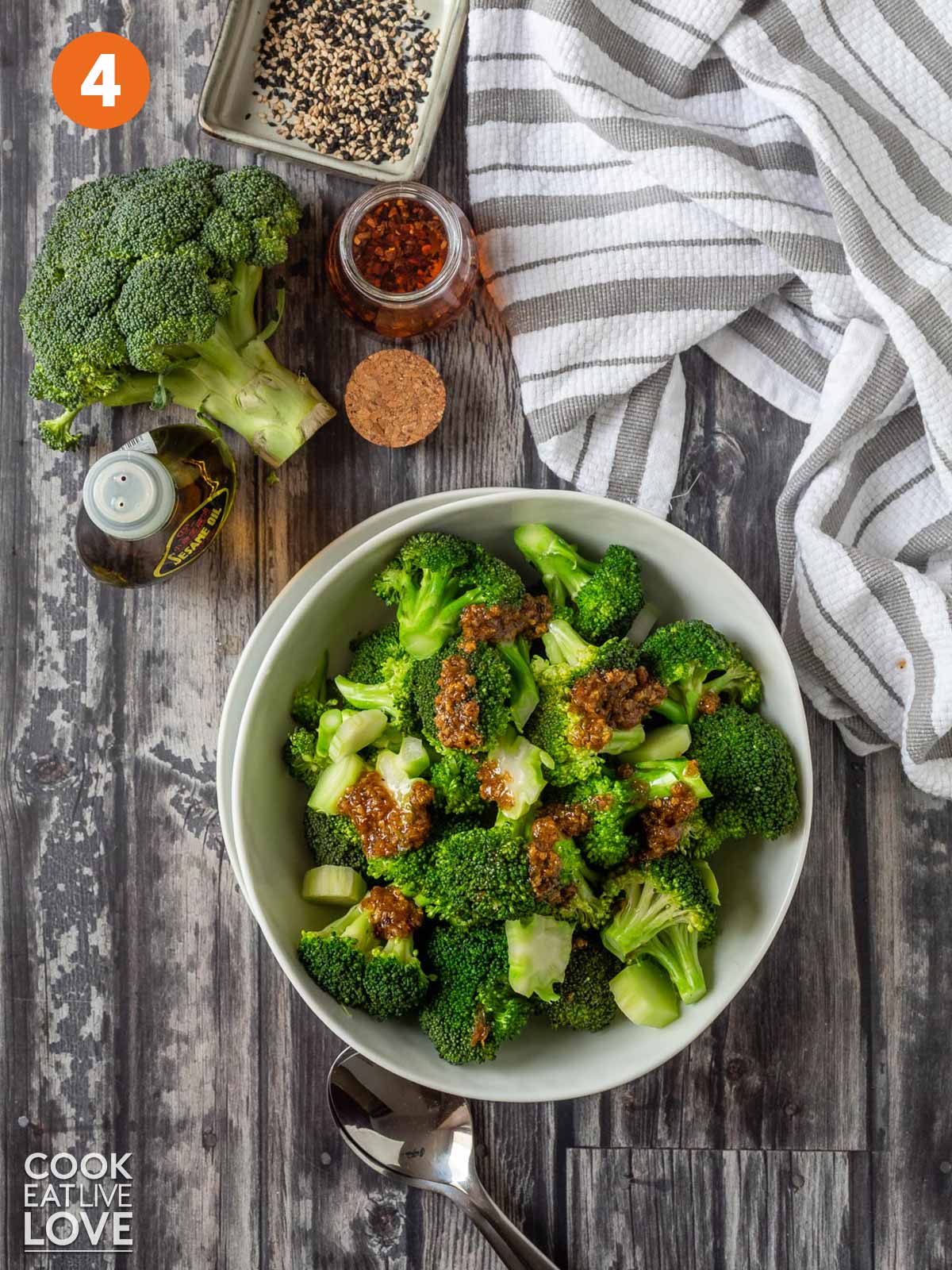 A bowl of broccoli topped with an Asian marinade.