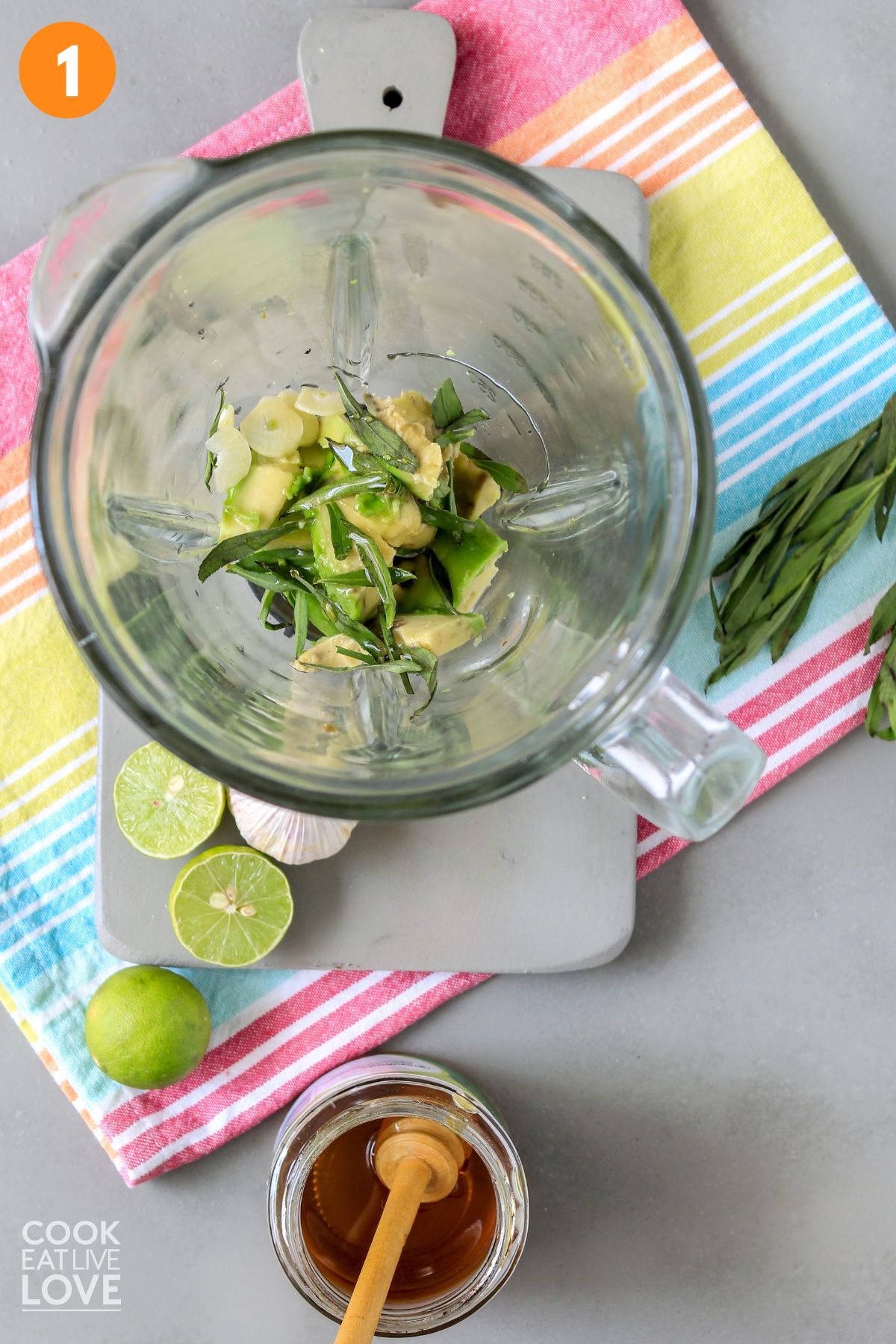 Ingredients to make avocado lime dressing are placed in a blender