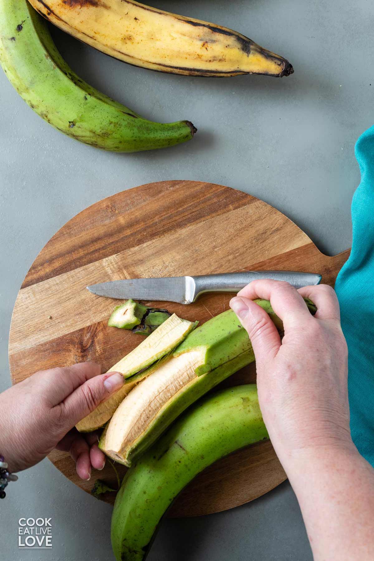Peeling off the skin on the plantain.