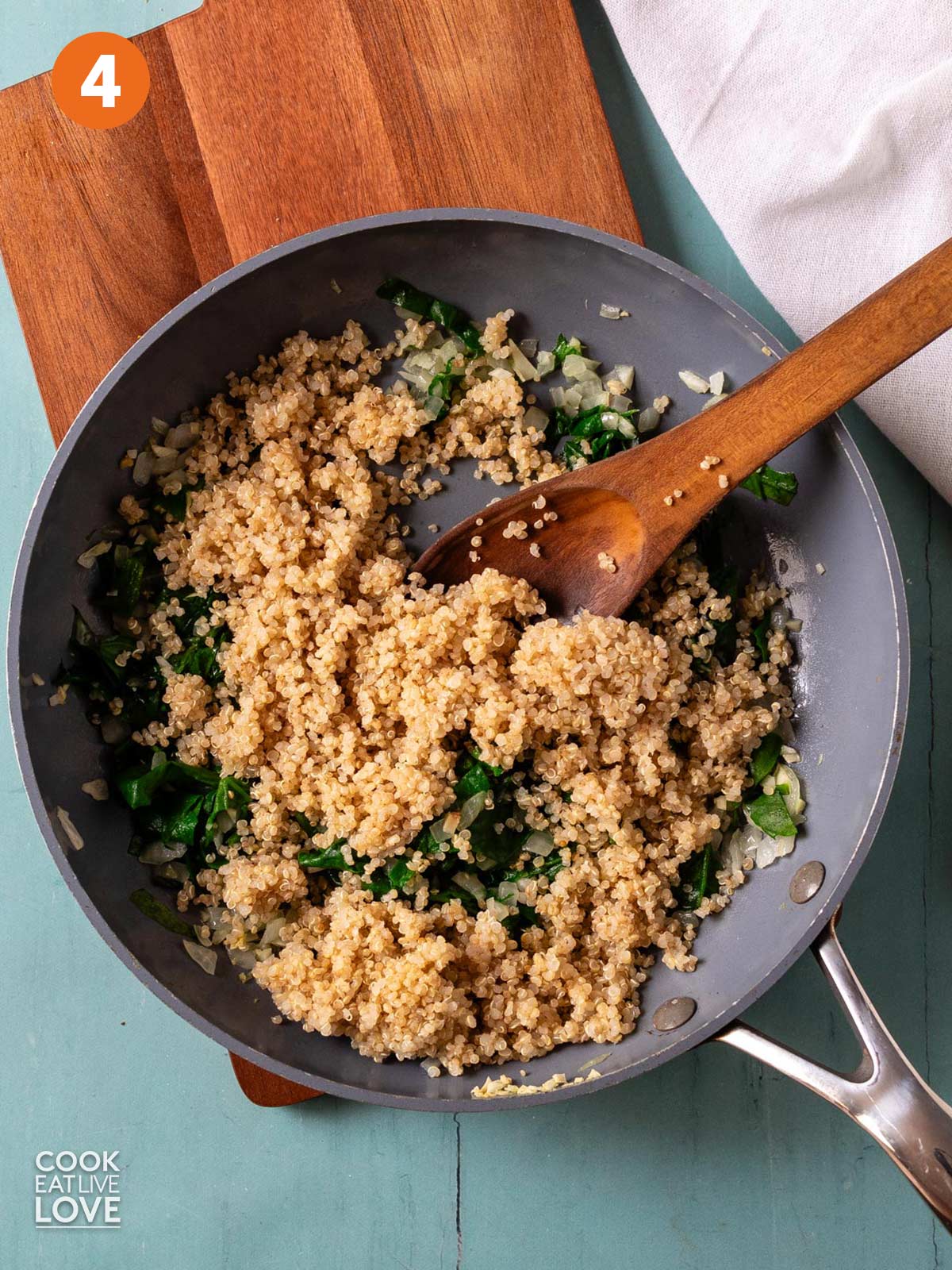 Quinoa added to the skillet to cook.