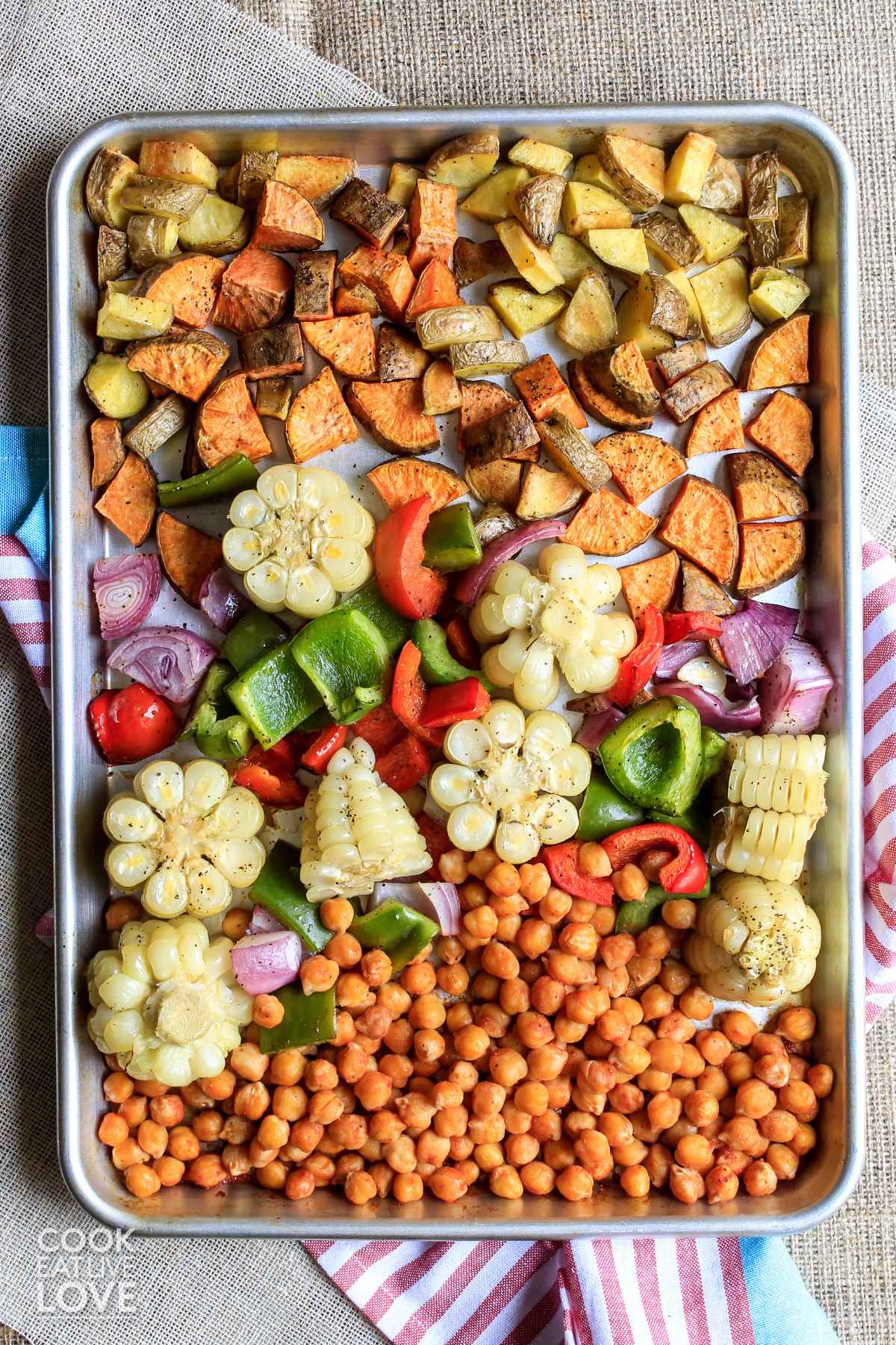 BBQ chickpeas and veggies cooked and ready on the sheet pan.