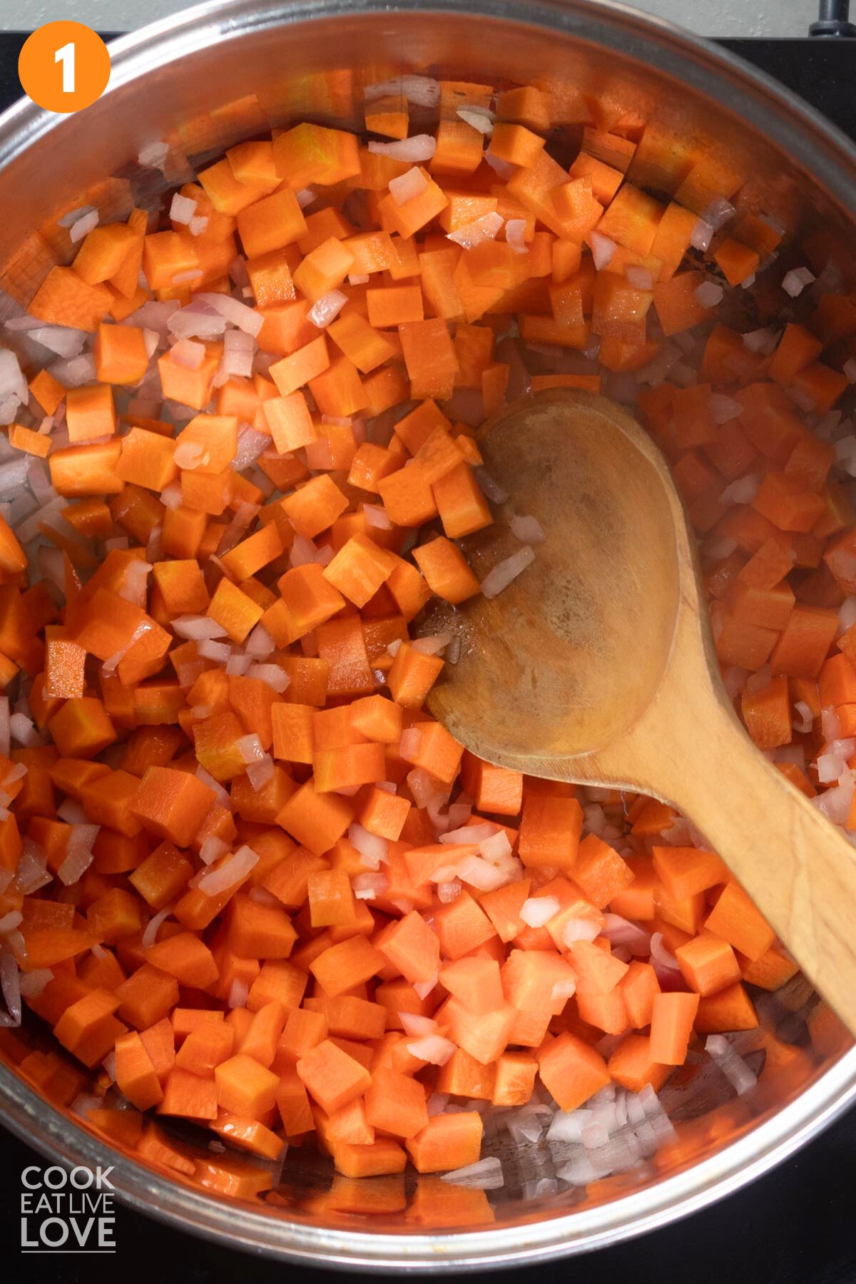 Carrots and onion cooking in a pot