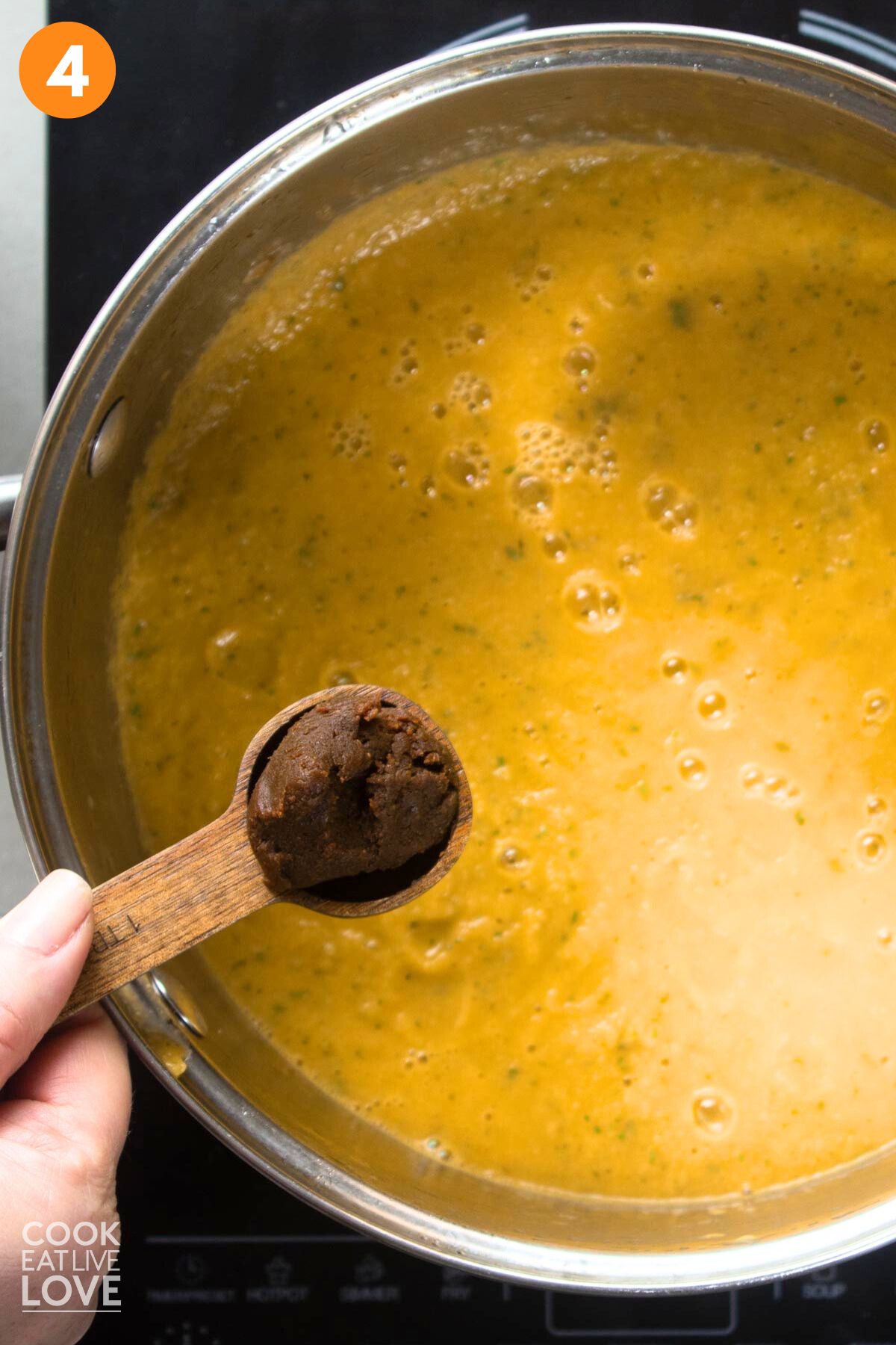 Adding the miso to the blended soup