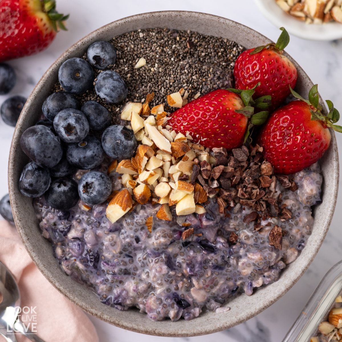 A bowl of chia seed overnight oats topped with a variety of different toppings.