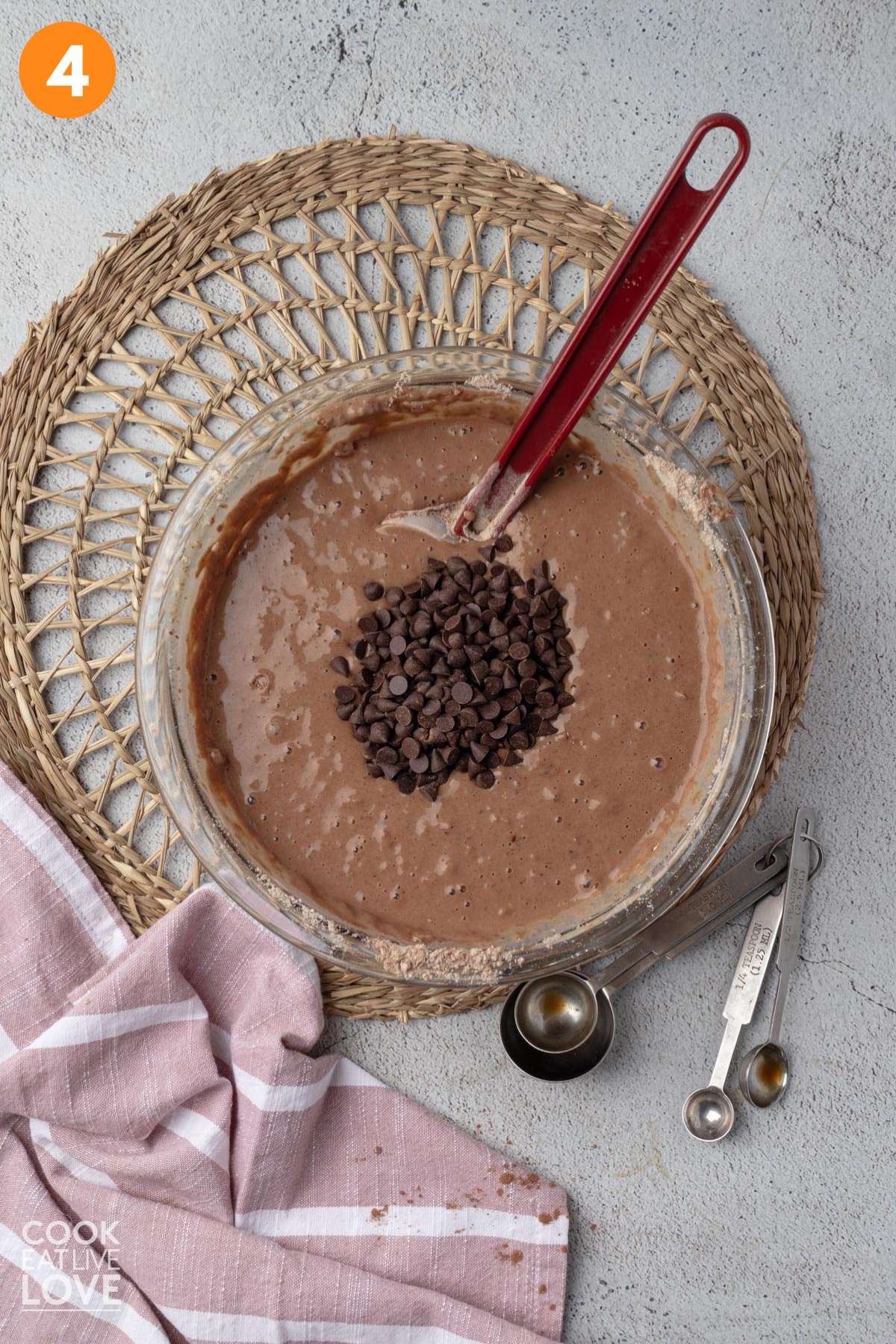 Chocolate chips added to bowl of mixed pancake batter.