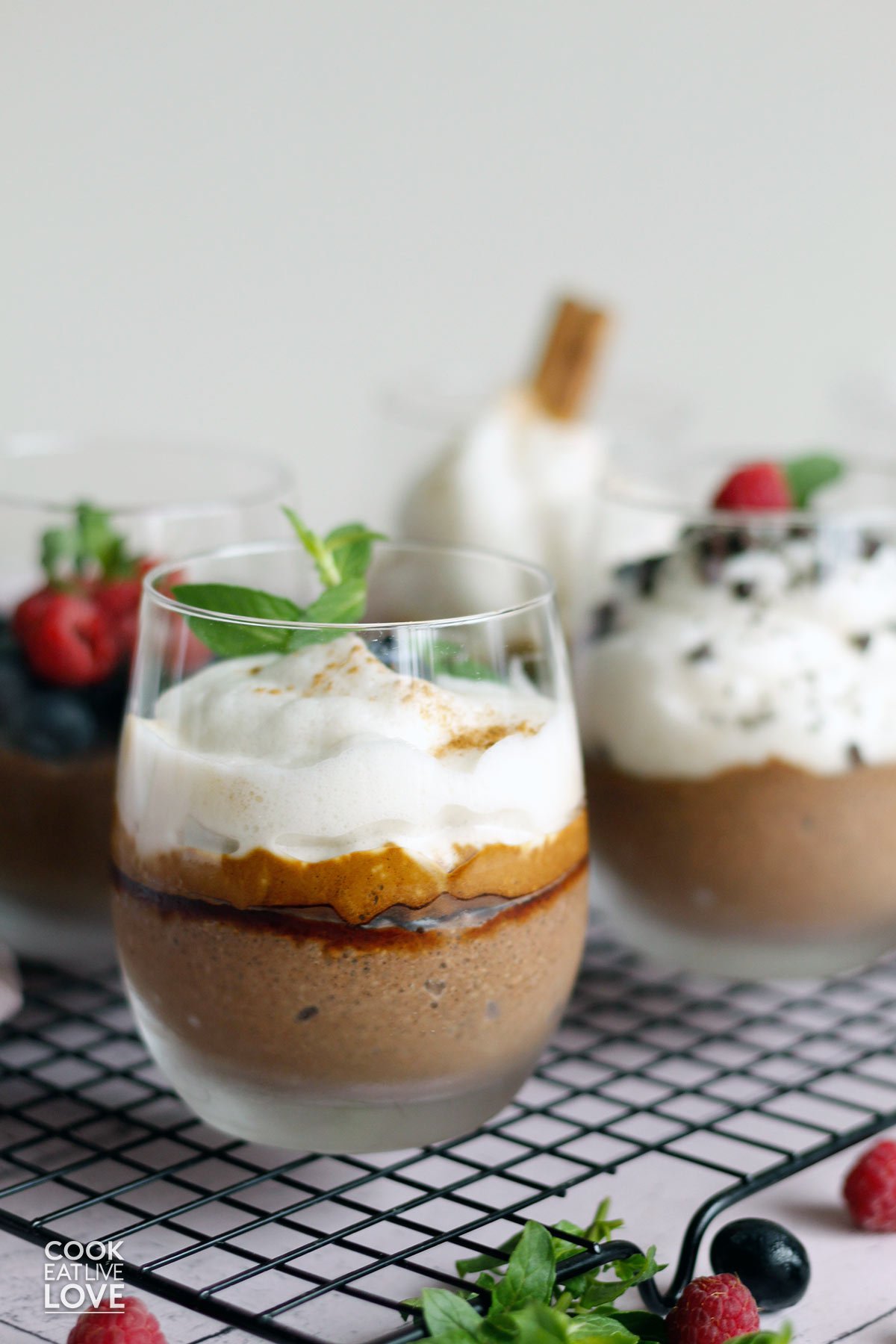 Chocolate chia seed pudding with coconut milk in glasses with different toppings.