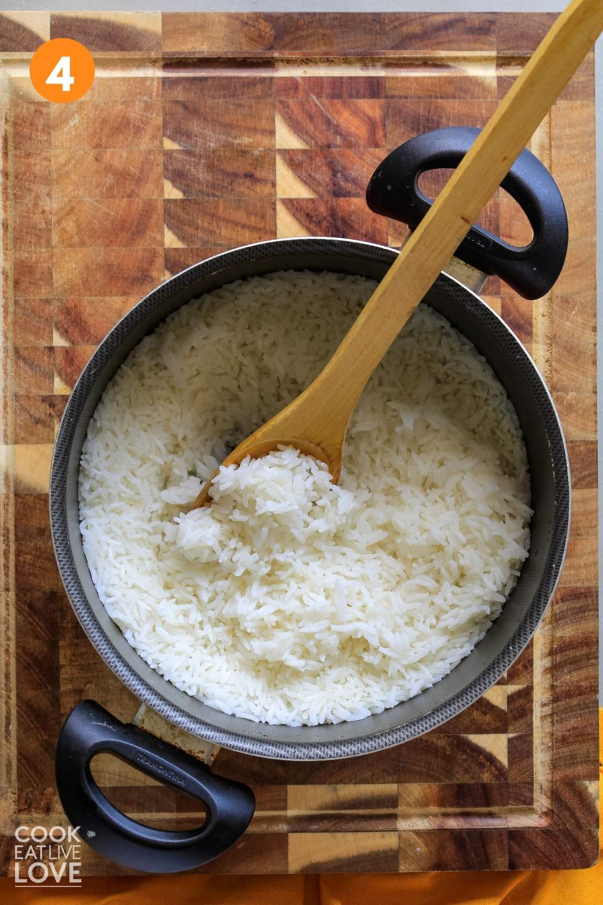 Cooked rice in a pot on a cutting board