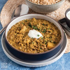 Lentil curry served up with vegan yogurt on the table