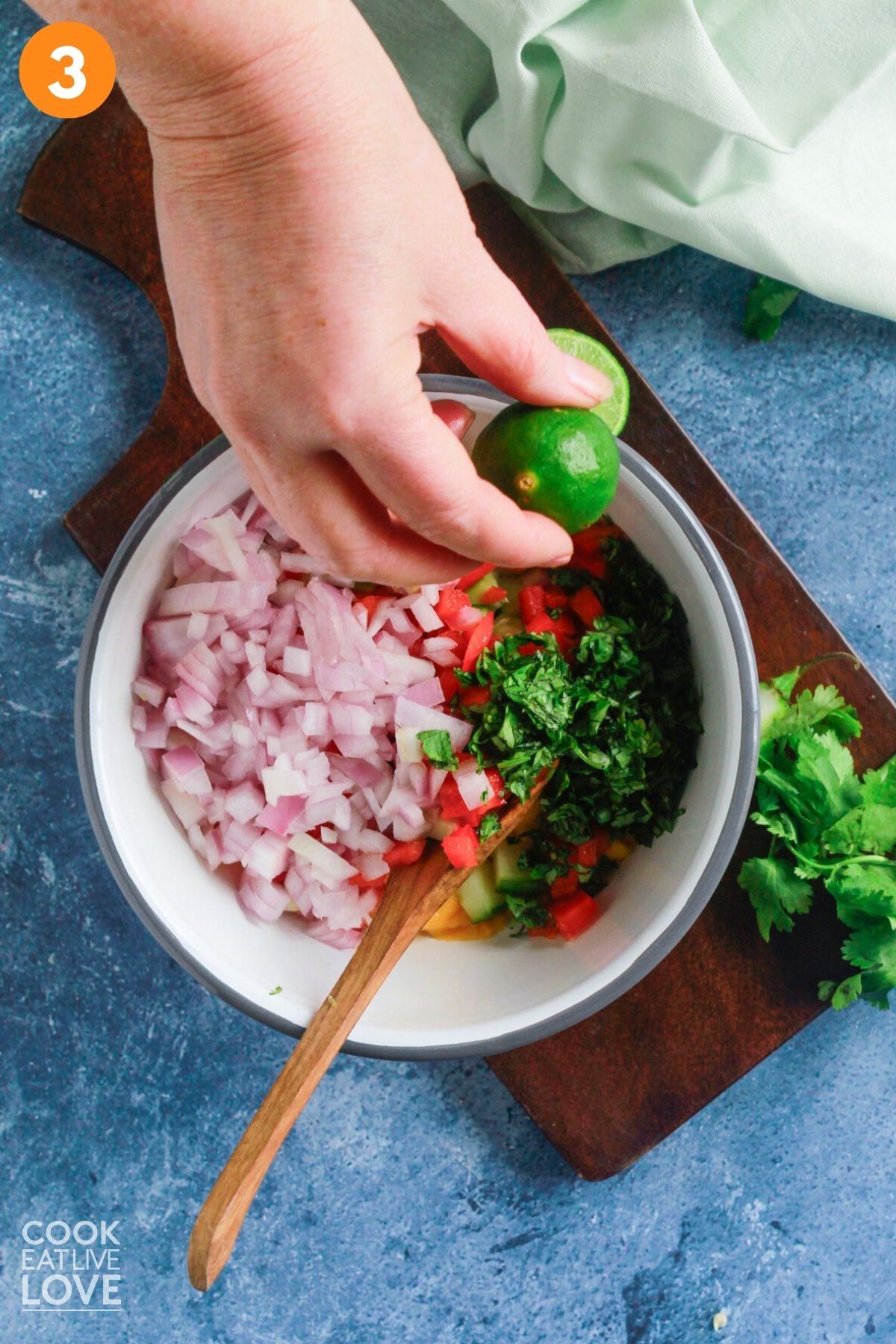 Squeezing fresh lime into the bowl.