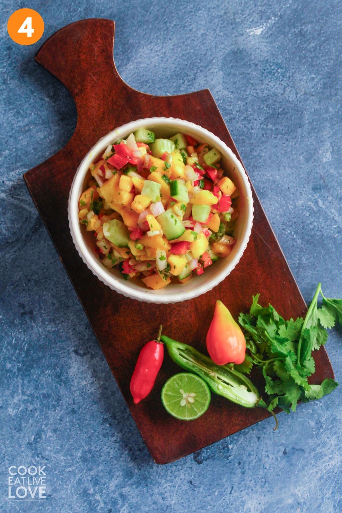 Fully mixed mango salsa in a bowl on the table.