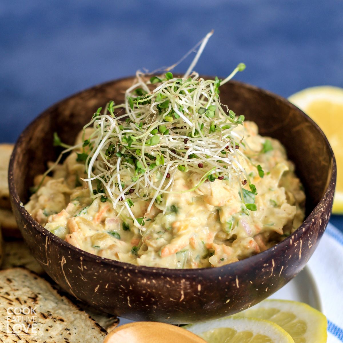 Bowl of chickpea salad on the table with crackers