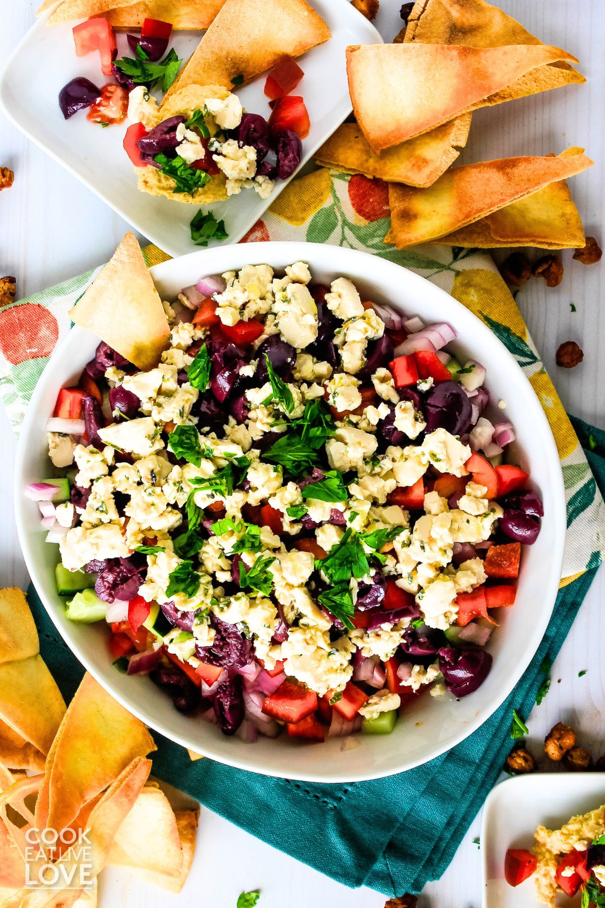 Overhead view of bowl of dip surrounded by pita chips.