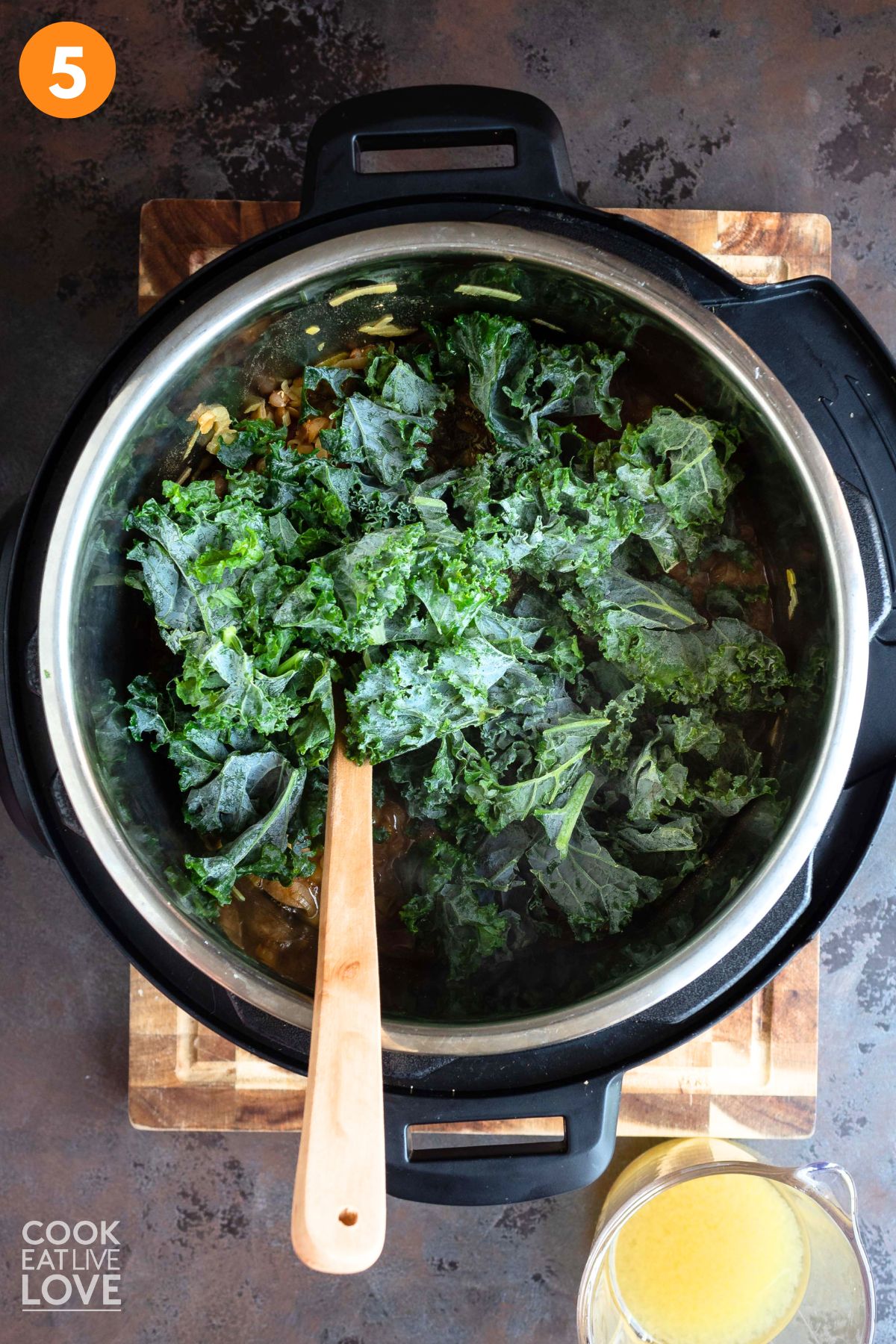 Kale added to the pot and lentil stew.