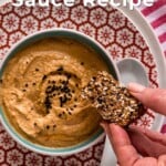 A pin for pinterest graphic with image of peanut sauce in a bowl and text on top.