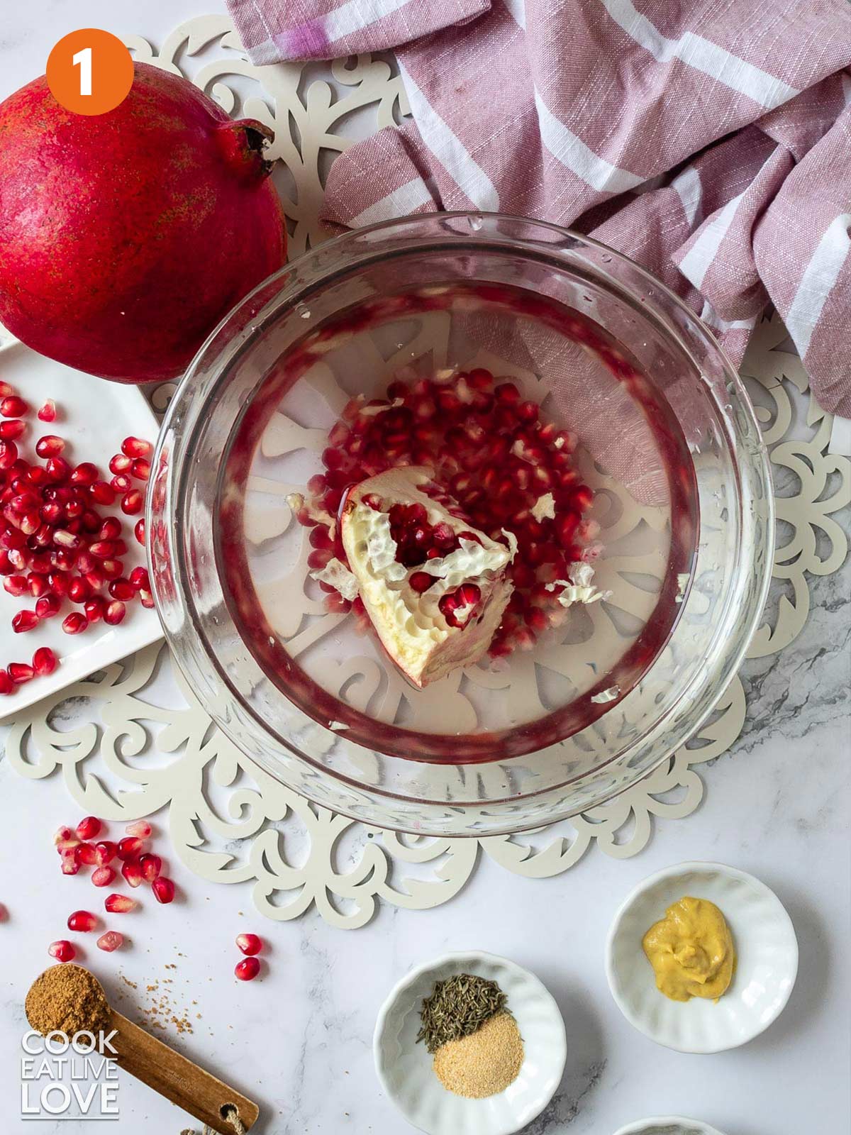 A piece of pomegranate in a bowl of water to remove the arils without making a mes.